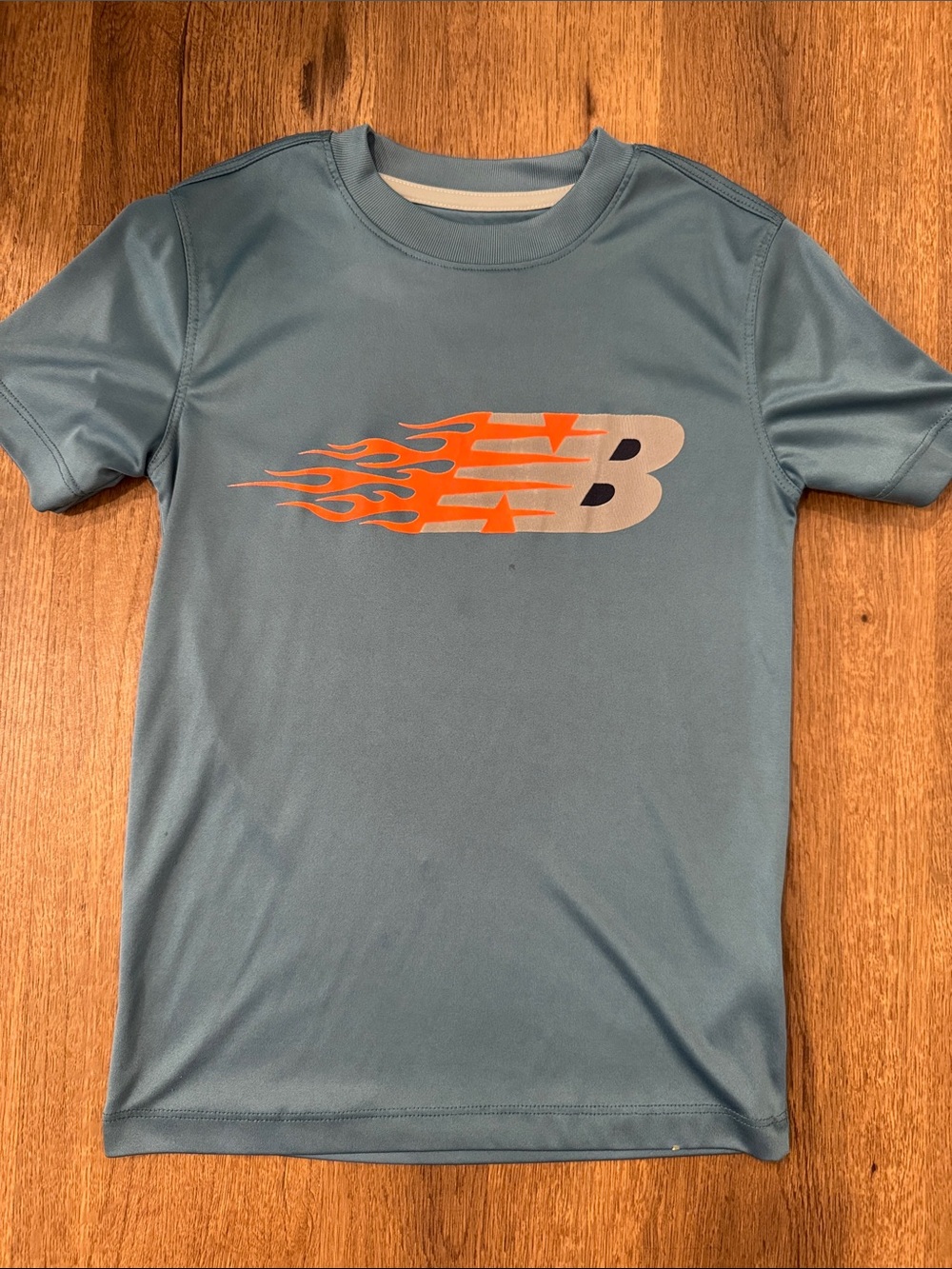 New Balance Light Blue Tee with Orange Flame Logo